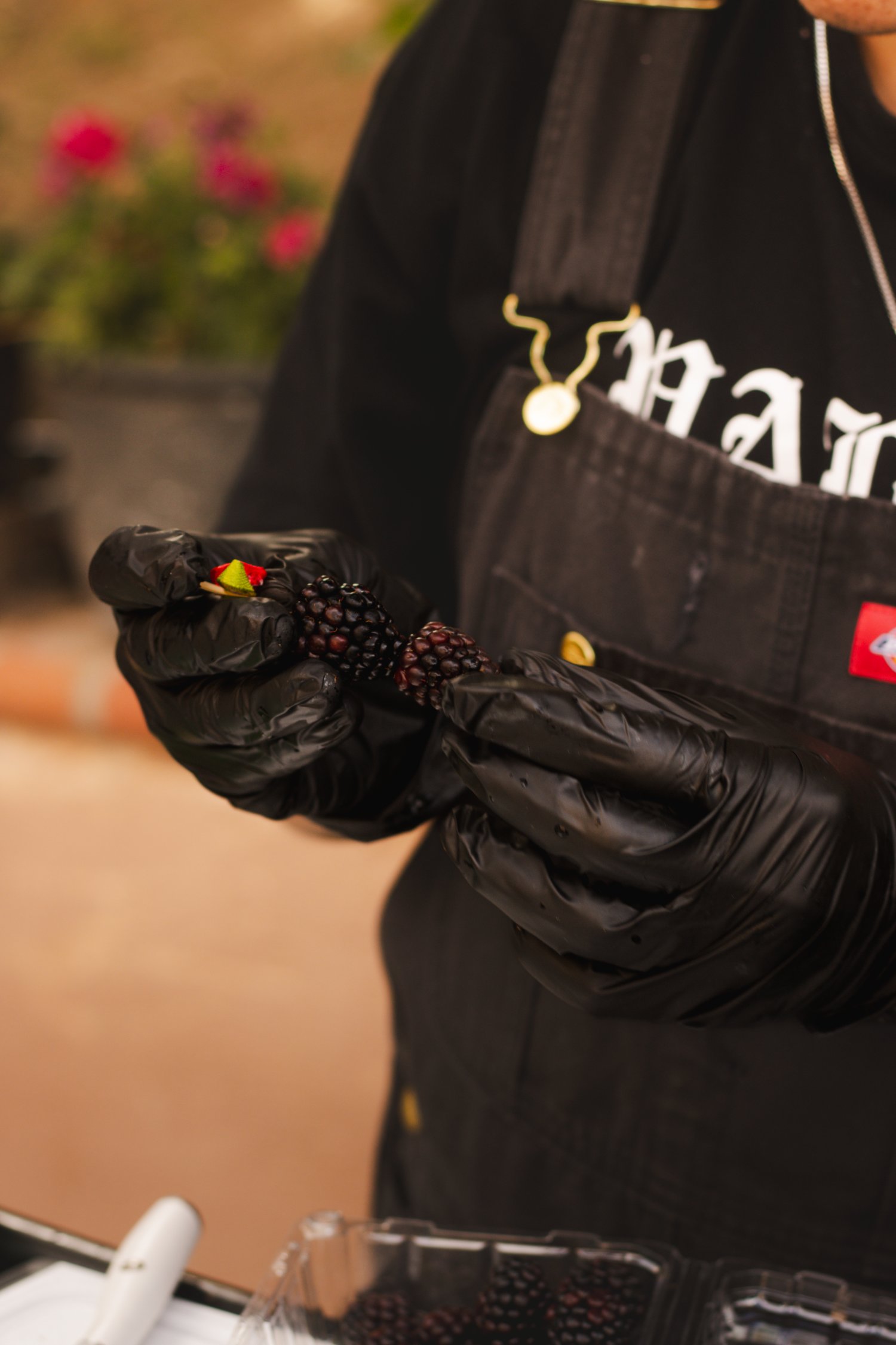 Bartender preparing a fresh blackberry garnish
